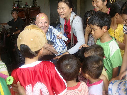 Suong & Dennis giving out toothbrushes
(although I must admit they were more interested in the toys and books)