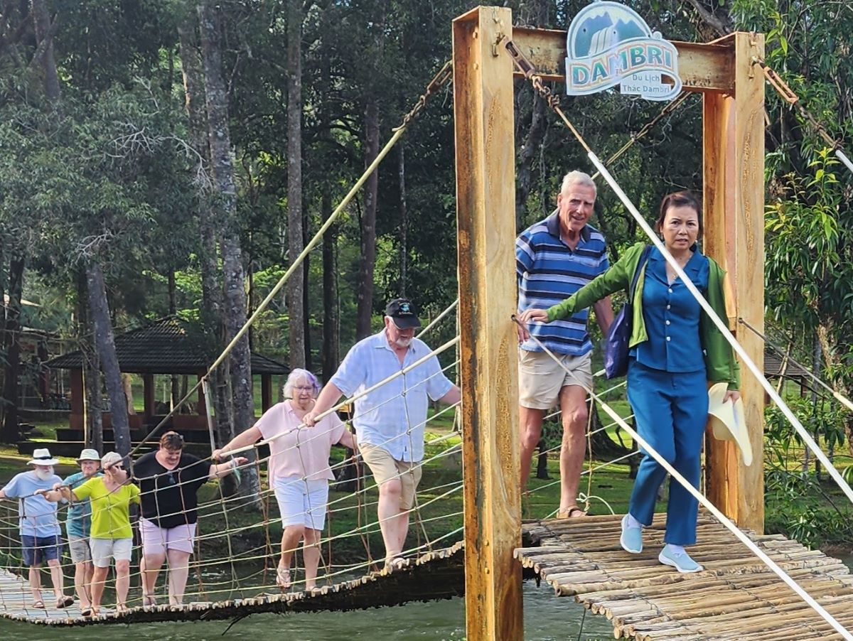 Hanging on as they cross the bridge at Dambri