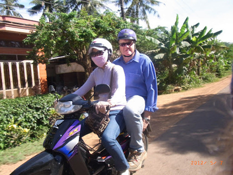 Miss Suong (Daughter, Sister, Mother, Auntie, Taxi bike rider) and the man mountain Ian Anderson on–route to the family home in the paddy fields of Binh Dinh to commence the Football Clinic!